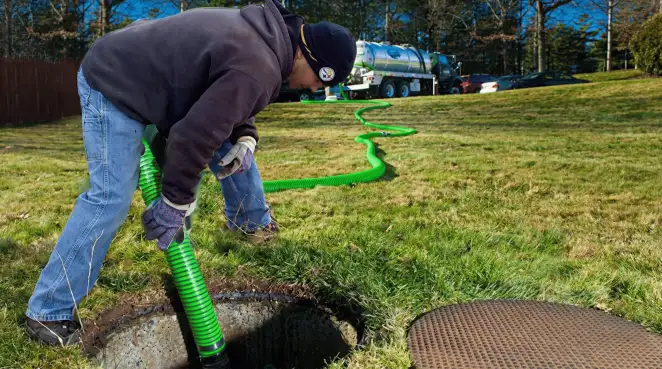 Service technician performing residential septic pumping and drainage maintenance in Yonkers, NY